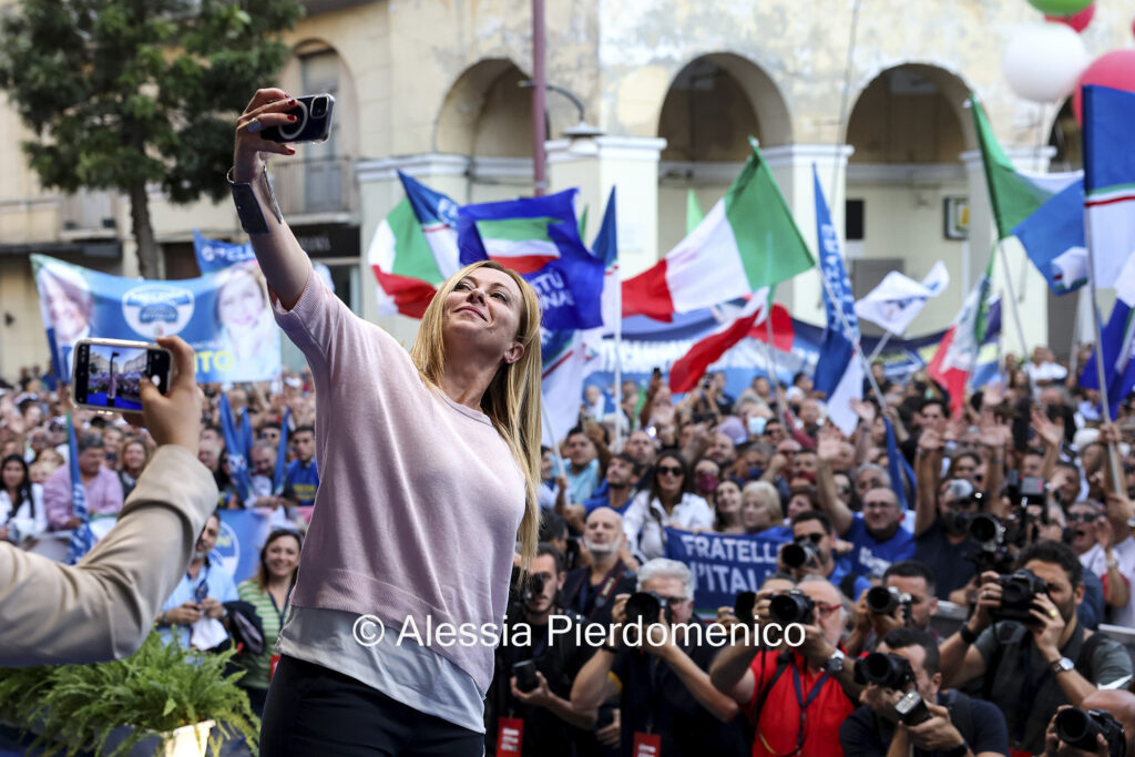 Giorgia Meloni, leader of the Brothers of Italy party, take a selfie at the end of an election campaign rally in Caserta, Italy, on Sunday, Sept. 18, 2022.